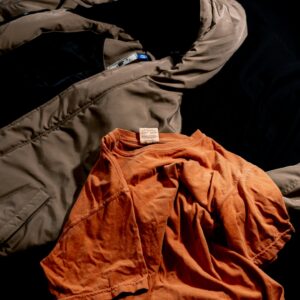An orange long sleeve cotton top laid flat