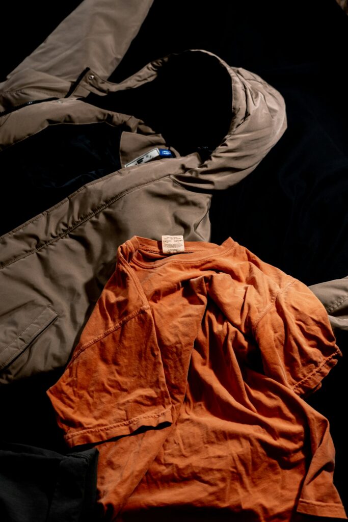 An orange long sleeve cotton top laid flat