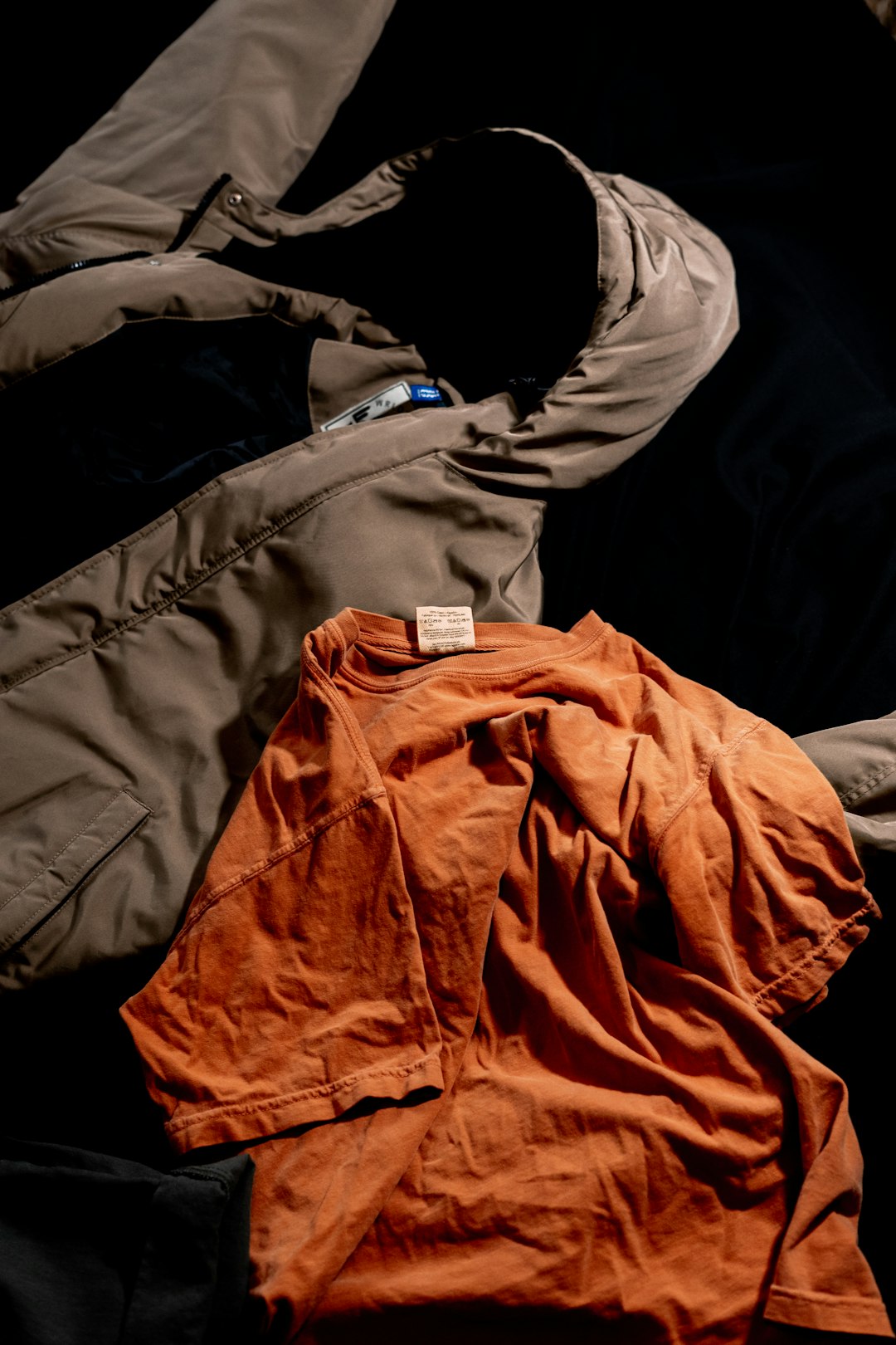 An orange long sleeve cotton top laid flat