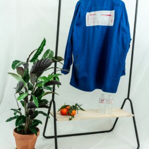 A blue cotton piqué polo shirt draped over a chair
