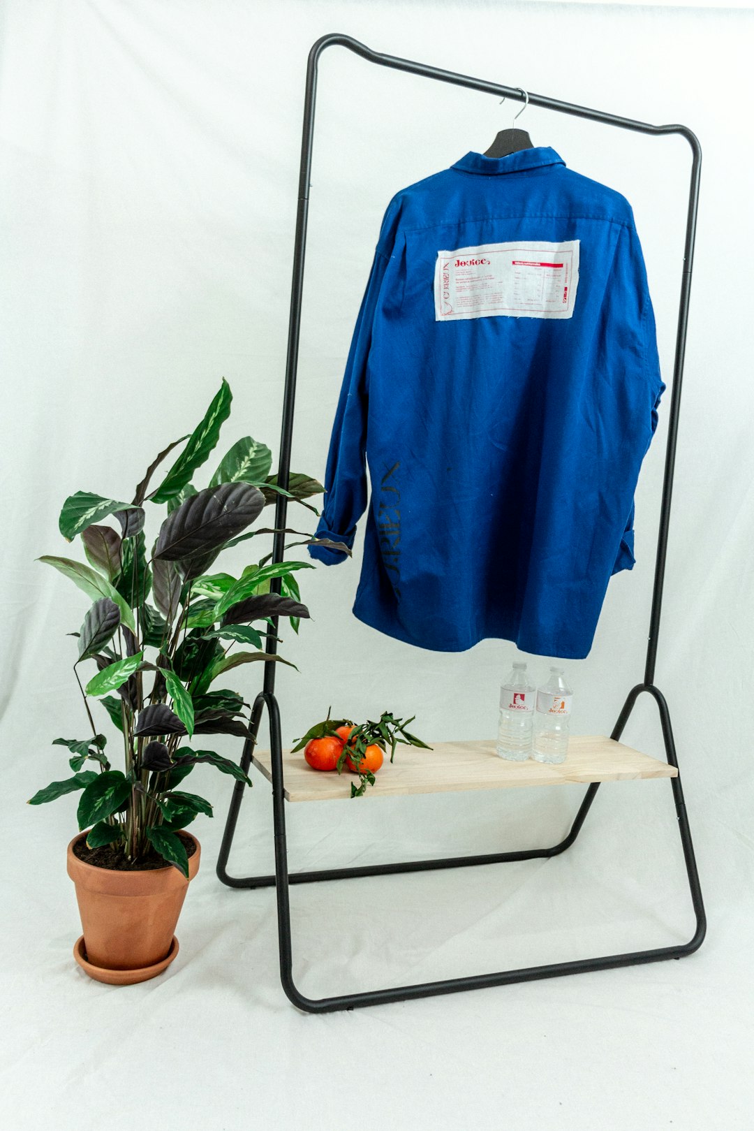A blue cotton piqué polo shirt draped over a chair