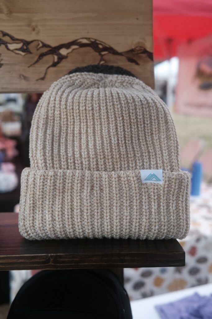 A knitted beanie resting on a wooden table